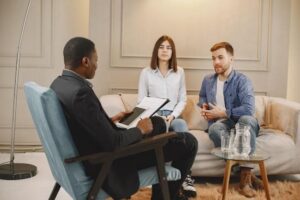 Consider Professional Support – couple talking with a therapist in an office setting.